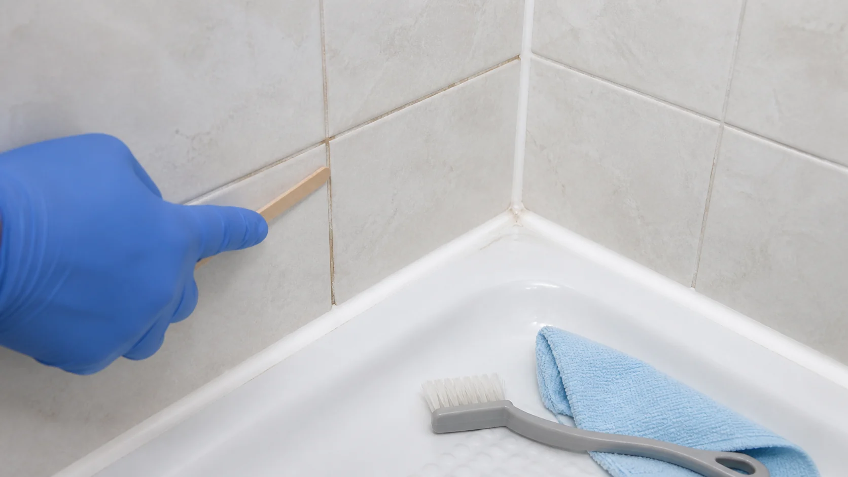Rozlišení cementové spáry mezi obklady a silikonového spoje v rohu vany